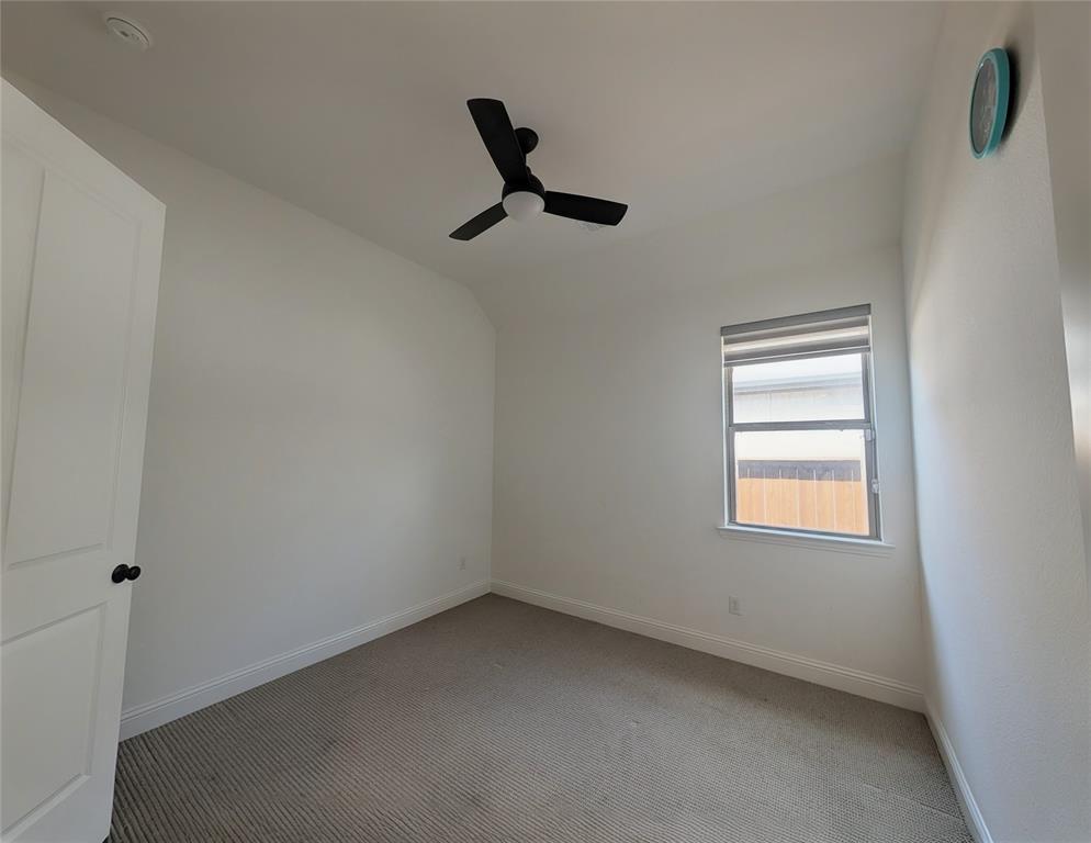 15532 Fringe Tree Road Frisco, TX 75035 - Photo 13 of 31 Interior room featuring neutral wall paint, gray carpet, a single window with blinds, and a black ceiling fan