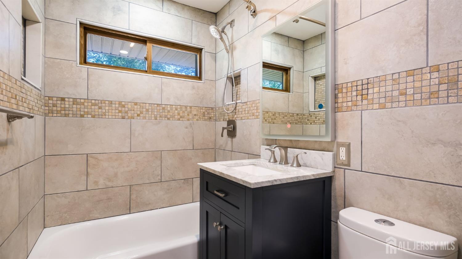 50 Sand Hills Road Kendall Park, NJ 08824 - Photo 21 of 27 a bathroom with a sink and a mirror