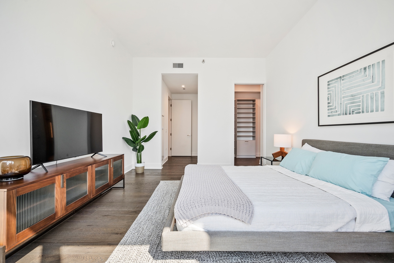 60 East Randolph Street, Unit 23B Chicago, IL 60601 - Photo 14 of 27 a bedroom with a bed and a flat screen tv