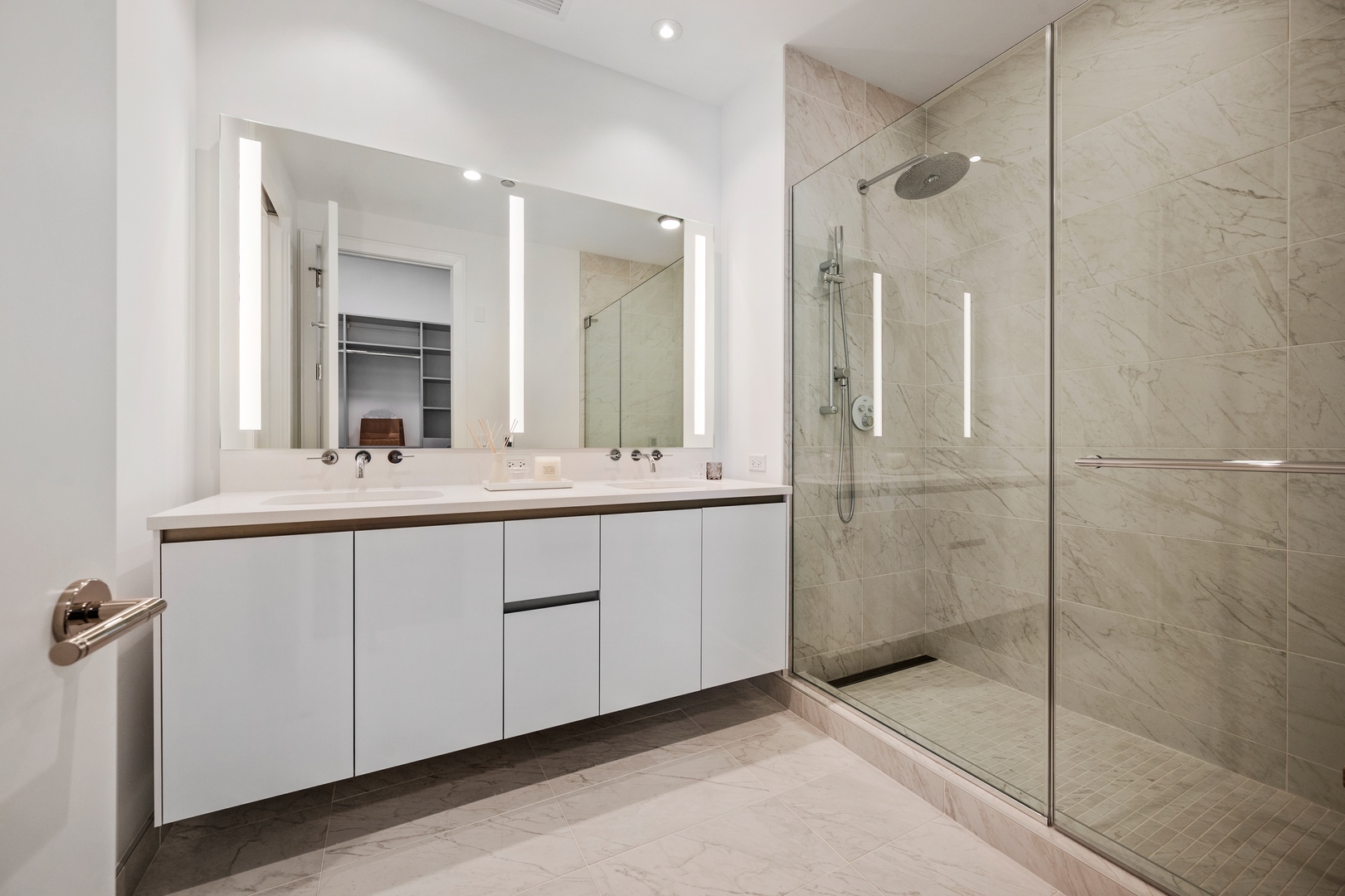 60 East Randolph Street, Unit 23B Chicago, IL 60601 - Photo 16 of 27 a bathroom with a double vanity sink mirror and shower