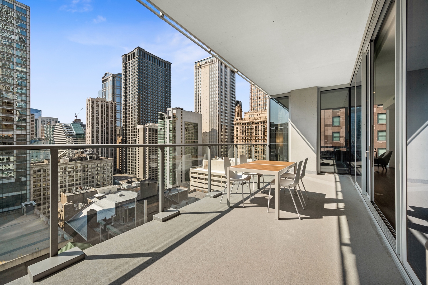 60 East Randolph Street, Unit 23B Chicago, IL 60601 - Photo 18 of 27 a view of balcony with two chairs and a potted plant on a table