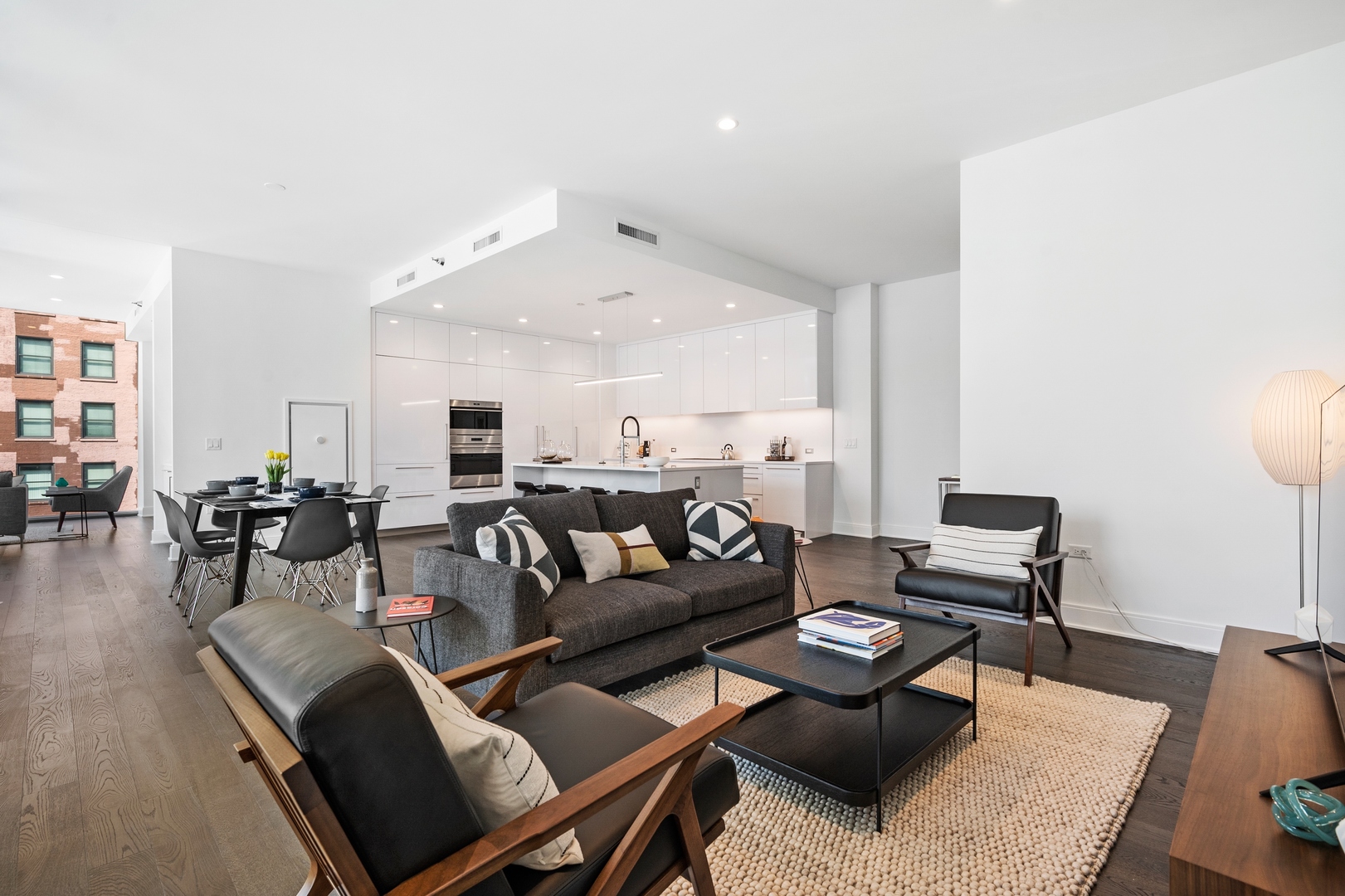 60 East Randolph Street, Unit 23B Chicago, IL 60601 - Photo 4 of 27 a living room with furniture and wooden floor