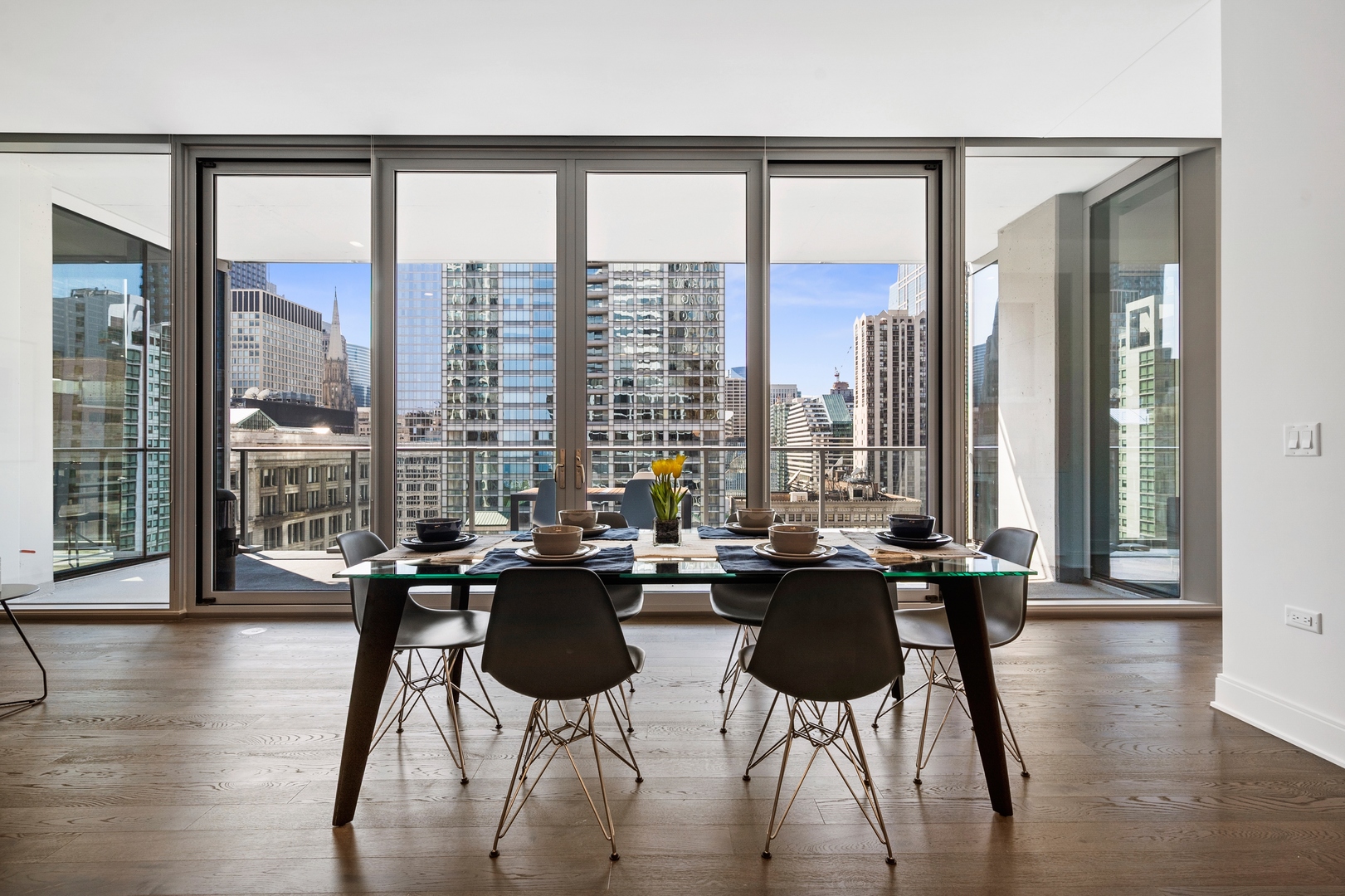 60 East Randolph Street, Unit 23B Chicago, IL 60601 - Photo 5 of 27 a very nice looking living room with a large window and dining table
