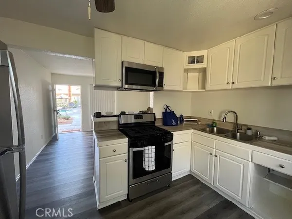 a kitchen with stainless steel appliances granite countertop a stove and a microwave