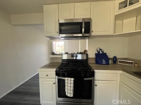 a kitchen with a stove and a microwave