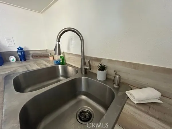 a kitchen with a sink a stove and microwave