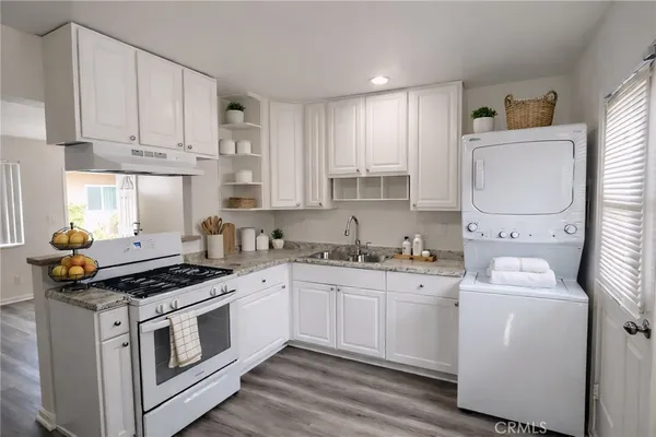 a kitchen with appliances a sink and cabinets