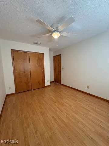 a view of an empty room and wooden floor