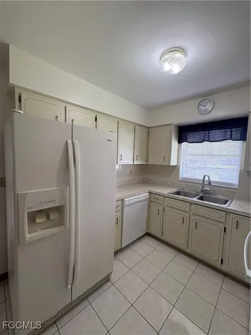a kitchen with refrigerator and sink