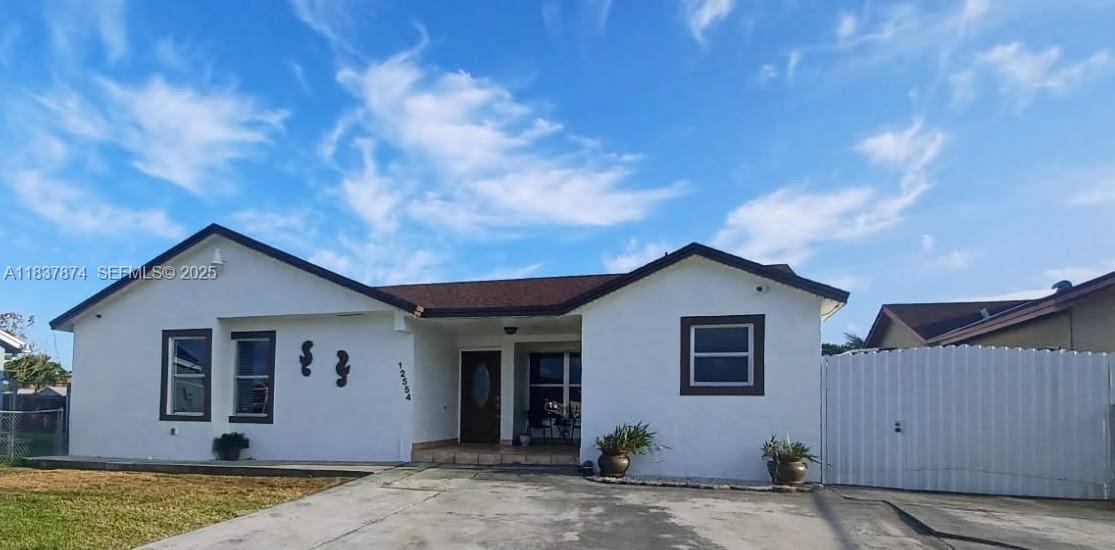 a view of a house with backyard space and garden