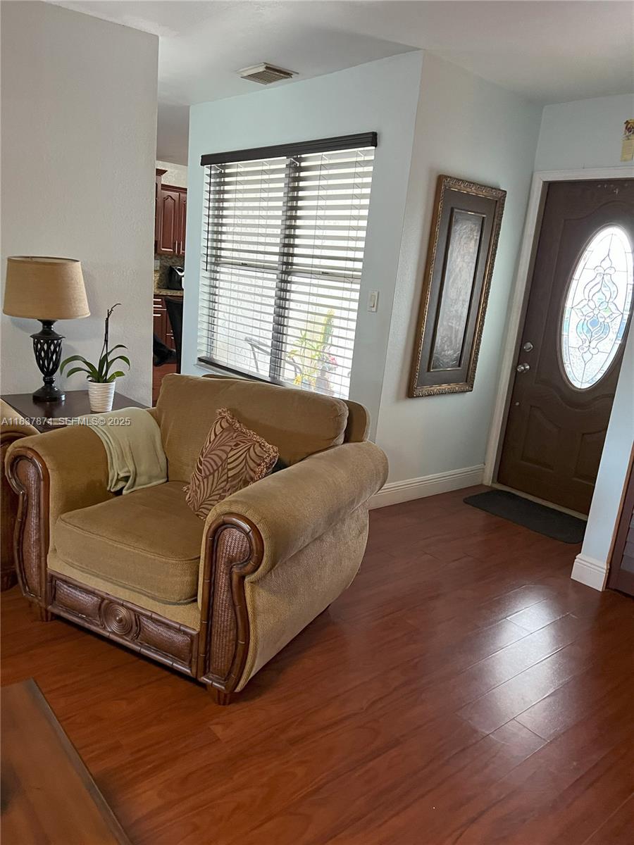 12554 Southwest 211th Terrace Miami, FL 33177 - Photo 12 of 30 a bed sitting in a bedroom next to a window