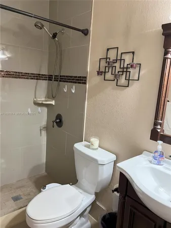 a white toilet sitting next to a bathroom sink