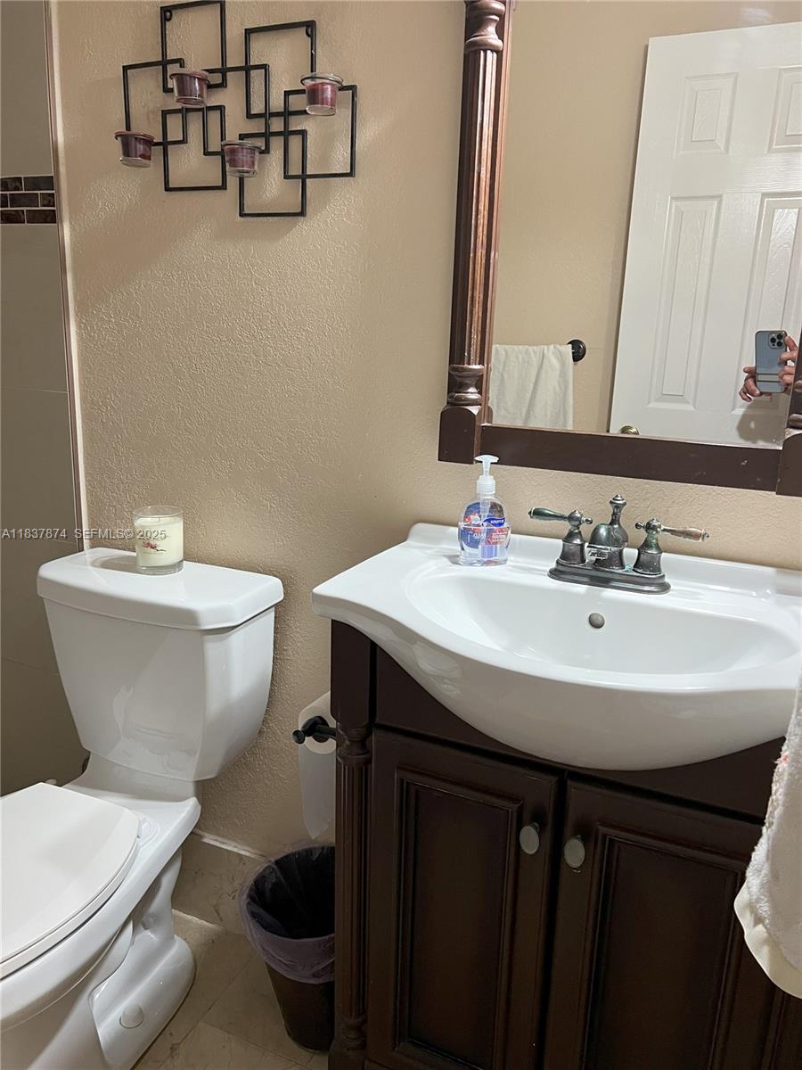 12554 Southwest 211th Terrace Miami, FL 33177 - Photo 14 of 30 a bathroom with a sink and a toilet