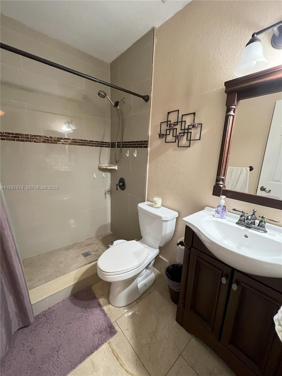 12554 Southwest 211th Terrace Miami, FL 33177 - Photo 15 of 30 a bathroom with a sink toilet and shower