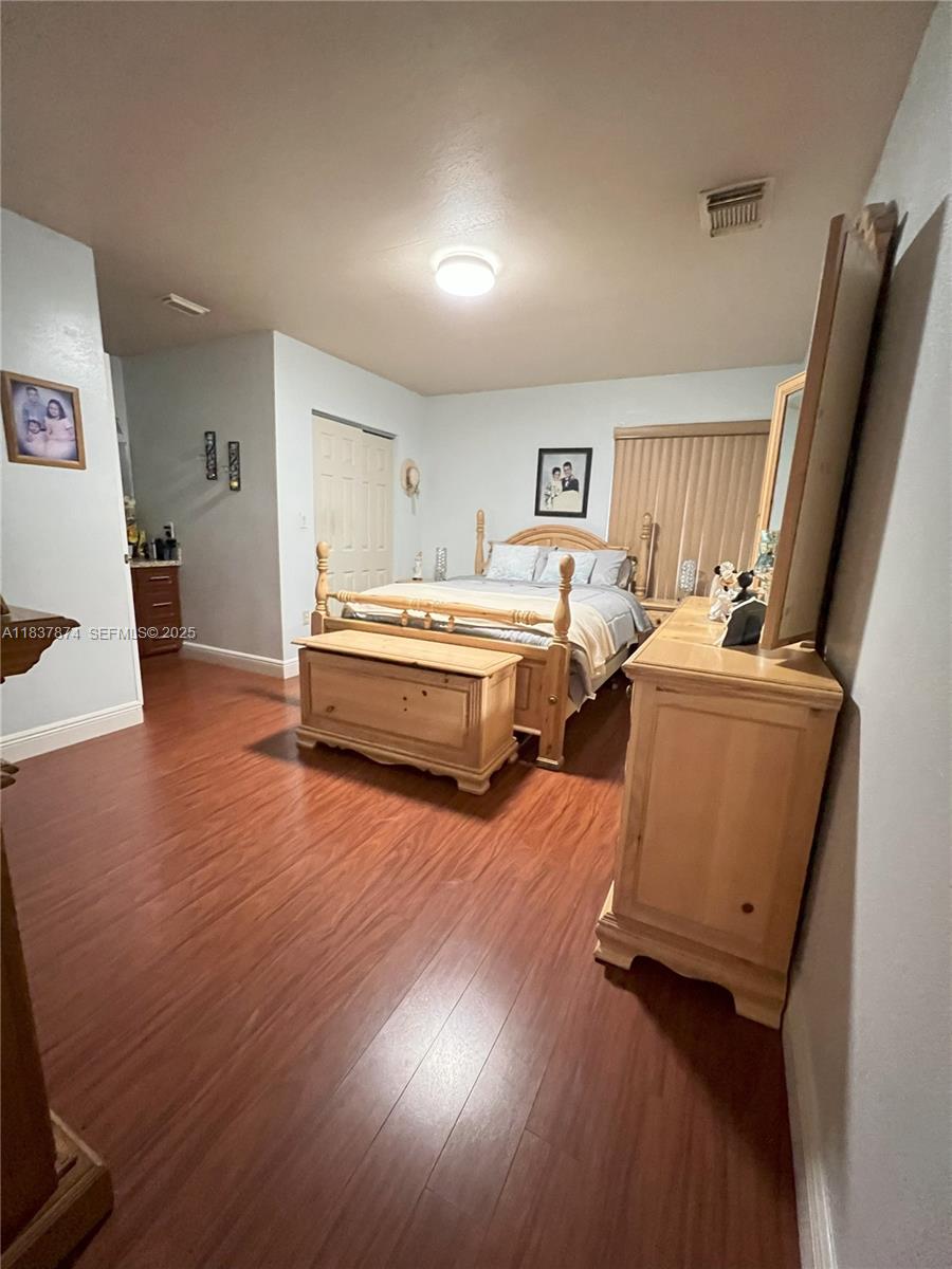 12554 Southwest 211th Terrace Miami, FL 33177 - Photo 19 of 30 a living room with furniture and a flat screen tv