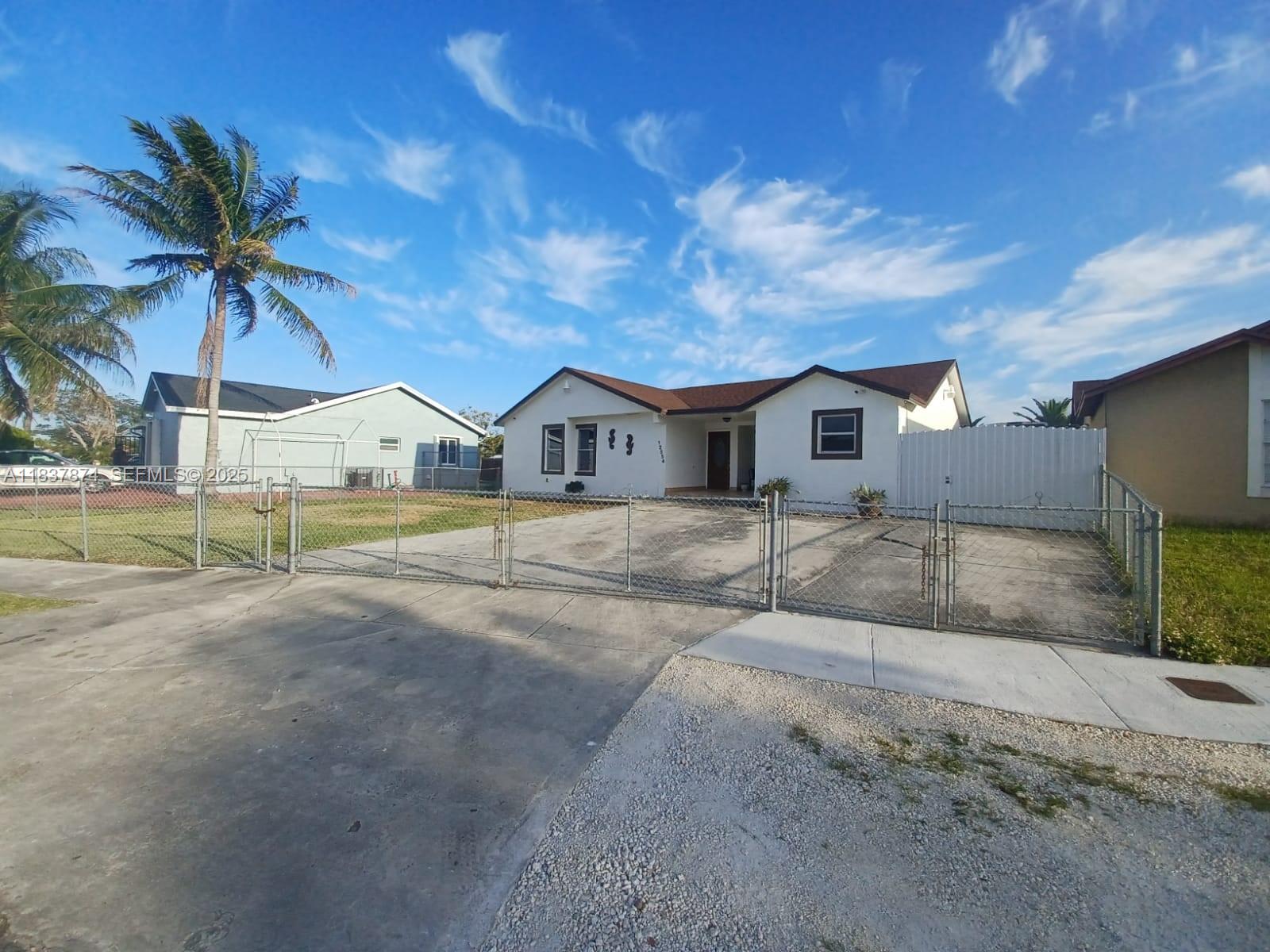 12554 Southwest 211th Terrace Miami, FL 33177 - Photo 2 of 30 a view of house with outdoor space and sitting area