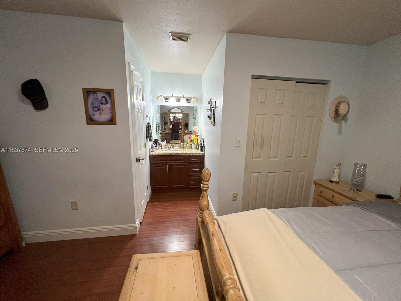 12554 Southwest 211th Terrace Miami, FL 33177 - Photo 21 of 30 a bedroom with a bed and a cabinets