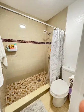 a bathroom with a toilet and shower