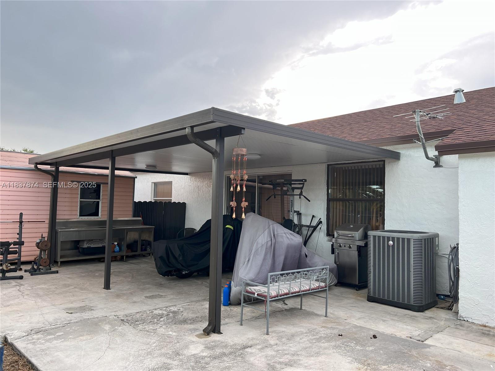 12554 Southwest 211th Terrace Miami, FL 33177 - Photo 28 of 30 a view of patio with table and chairs