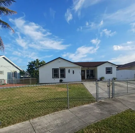 a house that has a tree in front of it