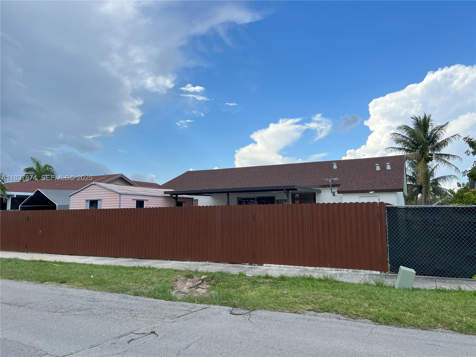 12554 Southwest 211th Terrace Miami, FL 33177 - Photo 4 of 30 a view of a house with a yard