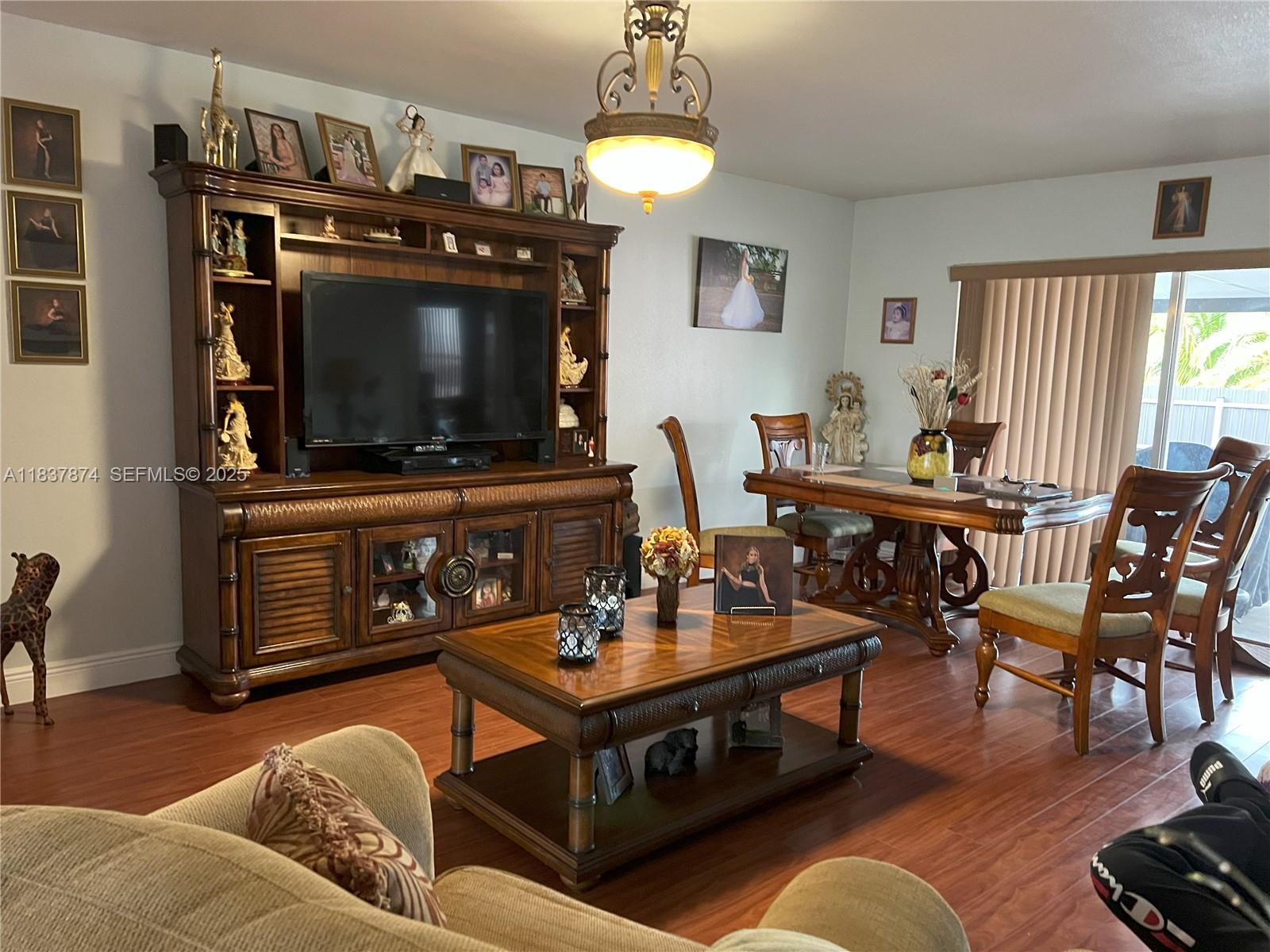 12554 Southwest 211th Terrace Miami, FL 33177 - Photo 7 of 30 a living room with furniture and a flat screen tv
