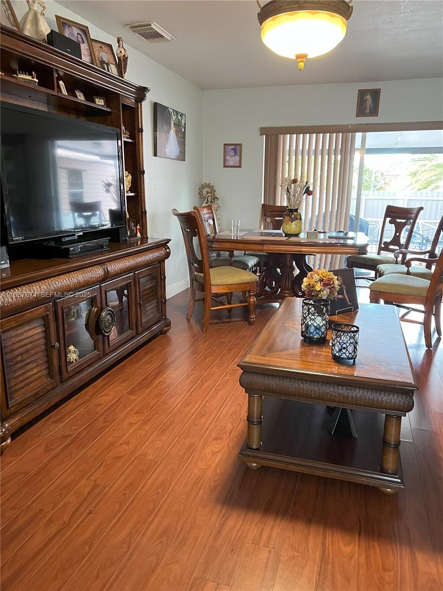 12554 Southwest 211th Terrace Miami, FL 33177 - Photo 8 of 30 a living room with furniture and a flat screen tv