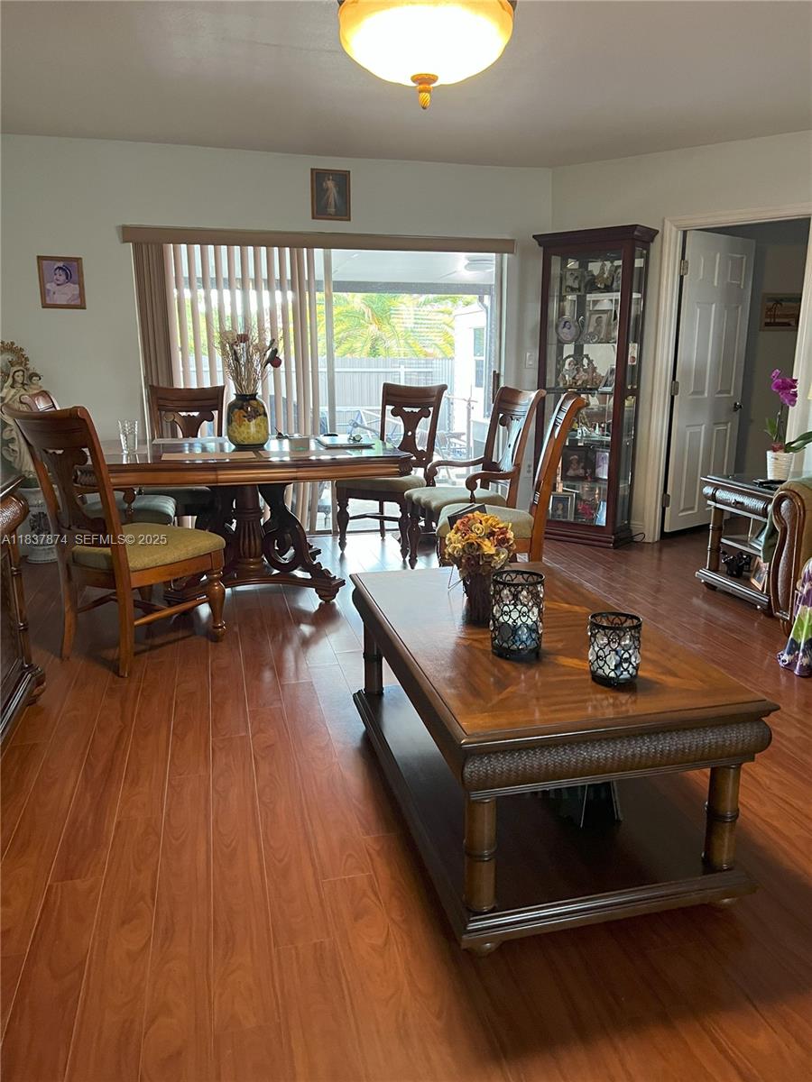 12554 Southwest 211th Terrace Miami, FL 33177 - Photo 9 of 30 a living room with furniture a wooden floor and a large window