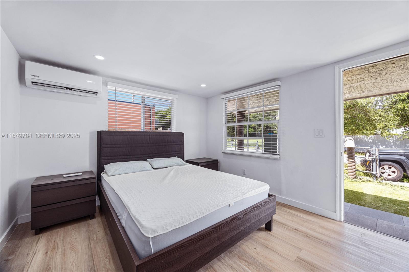 790 Northwest 63rd Street Miami, FL 33150 - Photo 16 of 35 a bedroom with a bed and a window