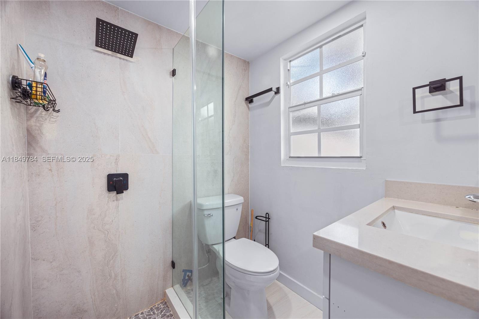 790 Northwest 63rd Street Miami, FL 33150 - Photo 19 of 35 a bathroom with a sink toilet and shower