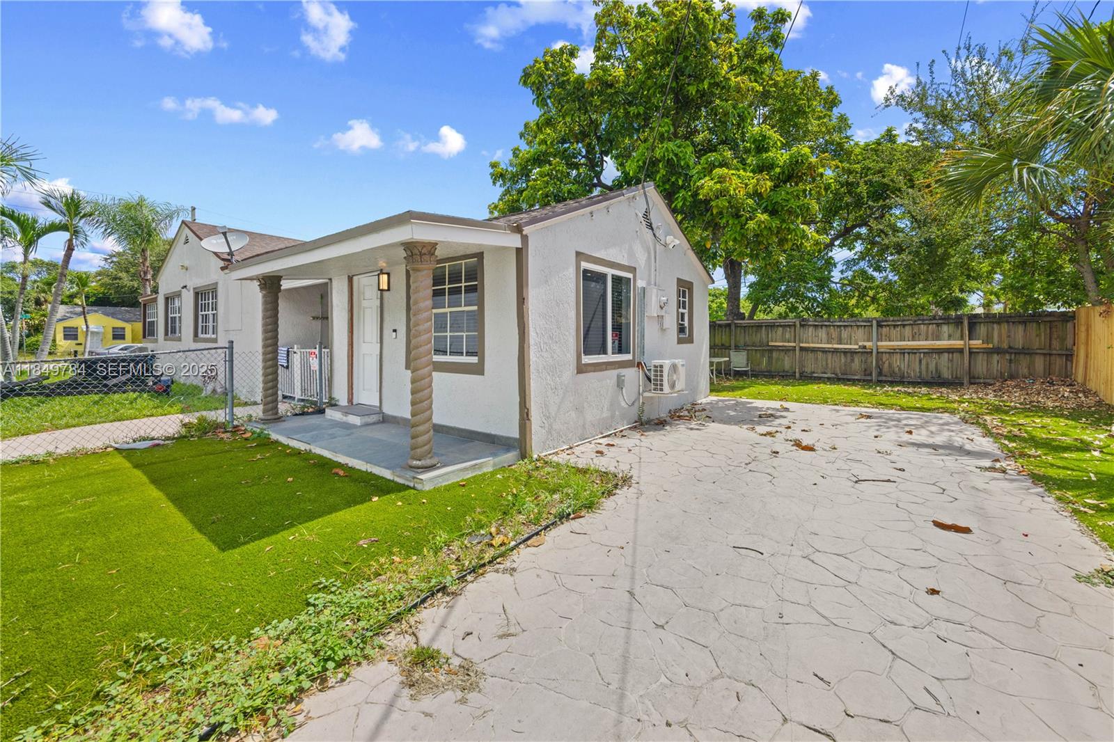 790 Northwest 63rd Street Miami, FL 33150 - Photo 21 of 35 a view of a house with swimming pool and a yard