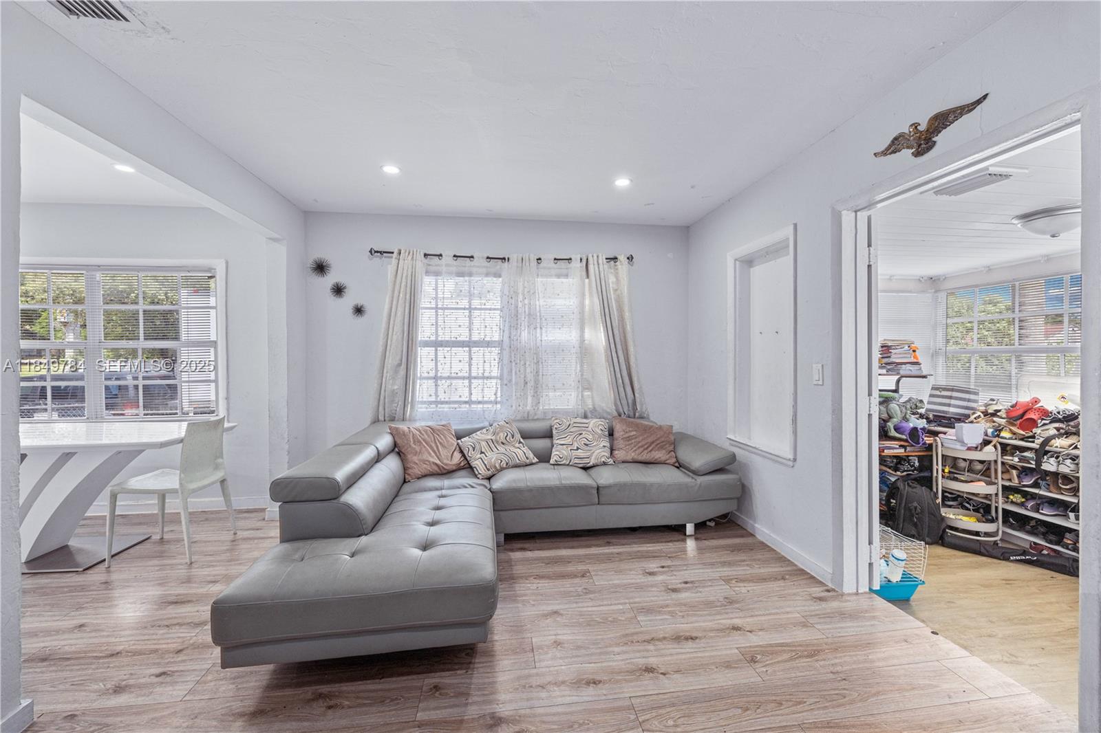 790 Northwest 63rd Street Miami, FL 33150 - Photo 3 of 35 a living room with furniture and a large window