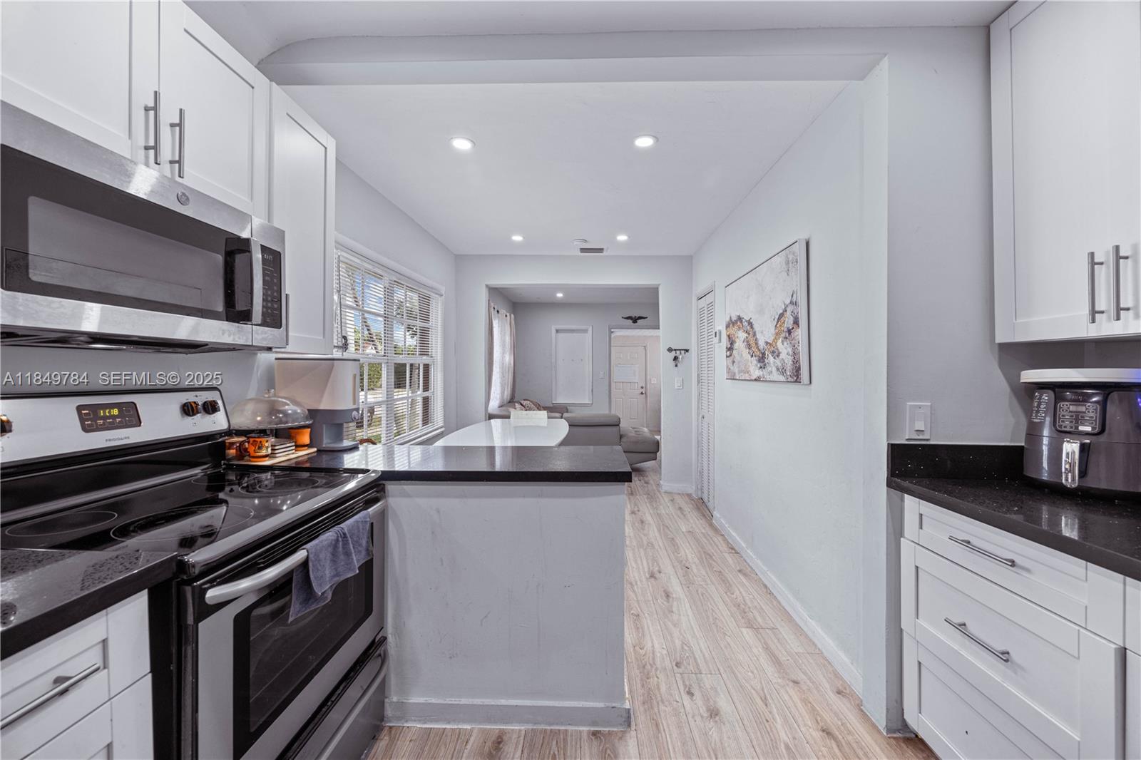 790 Northwest 63rd Street Miami, FL 33150 - Photo 9 of 35 a kitchen with a sink stove and microwave