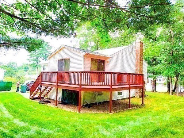 37 Heritage Road Billerica, MA 01821 - Photo 23 of 24 a view of a house with a yard chairs and a table under an umbrella