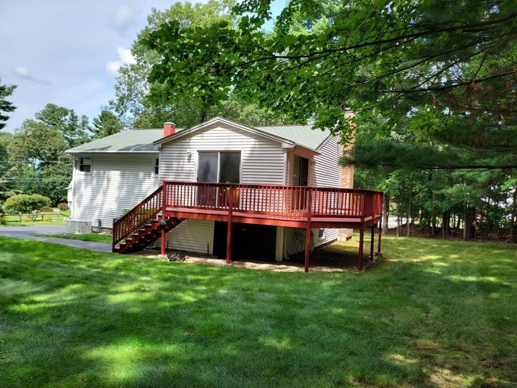 37 Heritage Road Billerica, MA 01821 - Photo 4 of 24 a view of a house with a big yard and a large tree