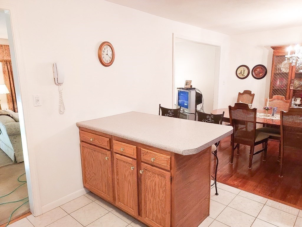 37 Heritage Road Billerica, MA 01821 - Photo 8 of 24 a view of kitchen island with a table and chairs