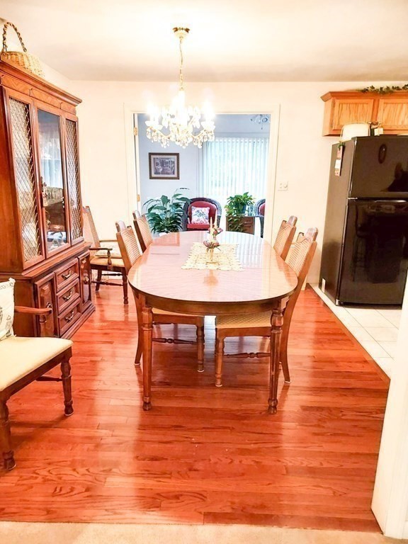 37 Heritage Road Billerica, MA 01821 - Photo 9 of 24 a dining room with furniture a window and wooden floor