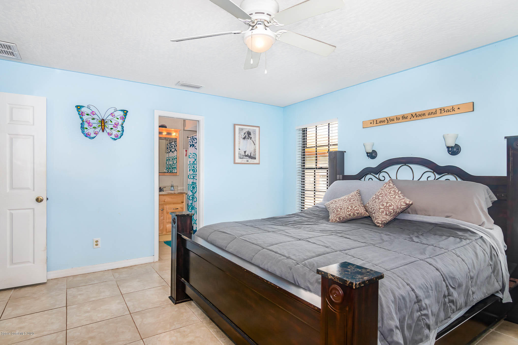 484 Rheine Road Northwest Palm Bay, FL 32907 - Photo 13 of 24 a bedroom with a bed and a chandelier