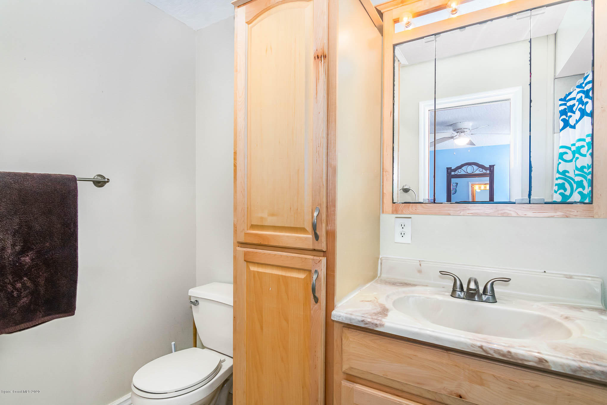 484 Rheine Road Northwest Palm Bay, FL 32907 - Photo 15 of 24 a bathroom with a granite countertop sink vanity mirror and toilet