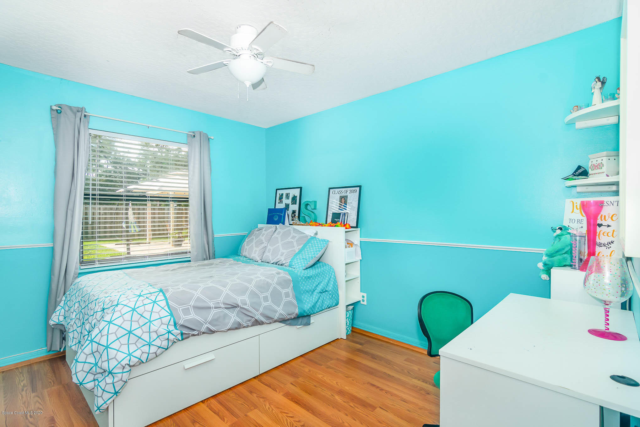 484 Rheine Road Northwest Palm Bay, FL 32907 - Photo 19 of 24 a bedroom with a bed and a chandelier
