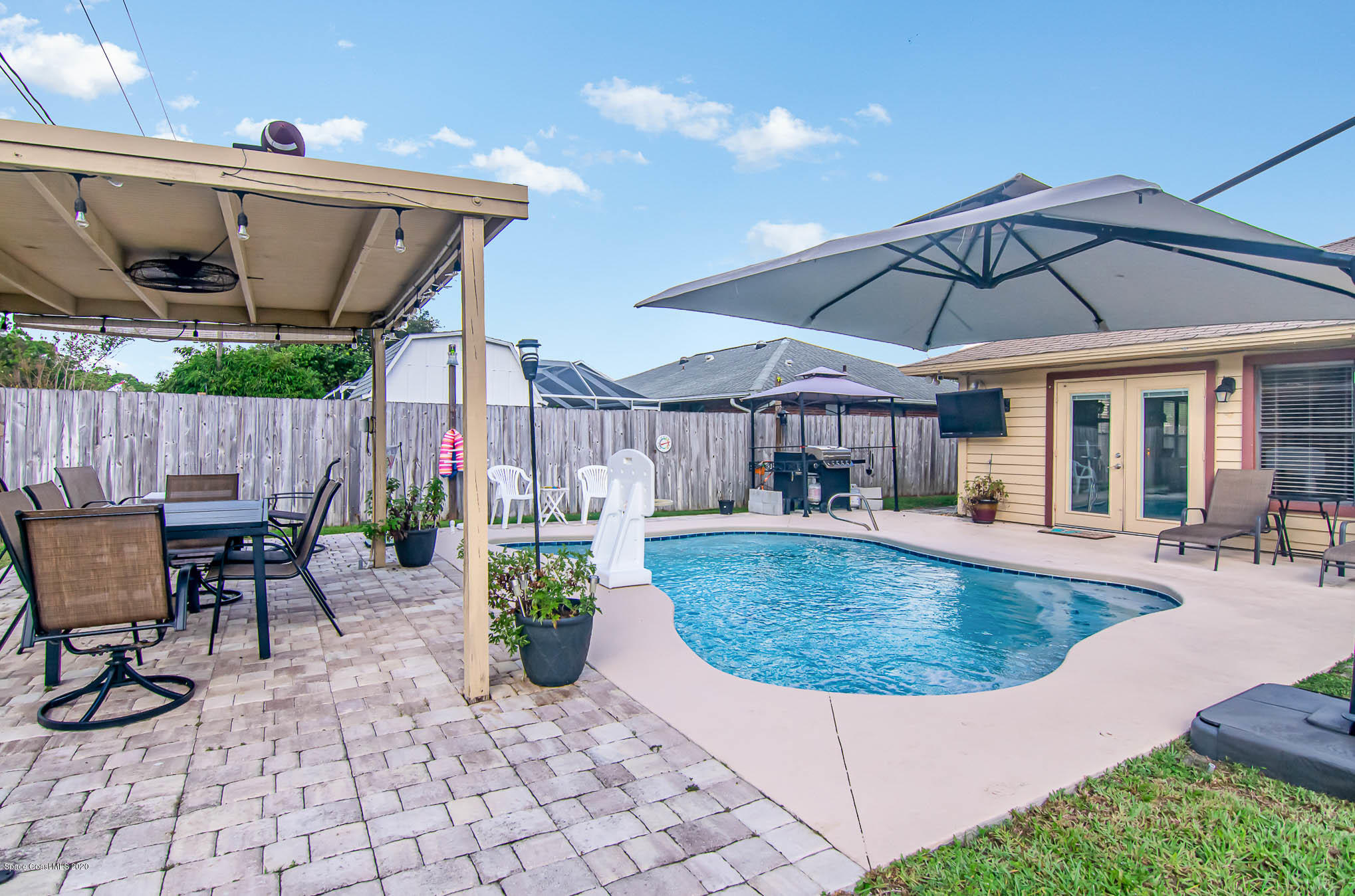 484 Rheine Road Northwest Palm Bay, FL 32907 - Photo 21 of 24 a view of a swimming pool with a patio