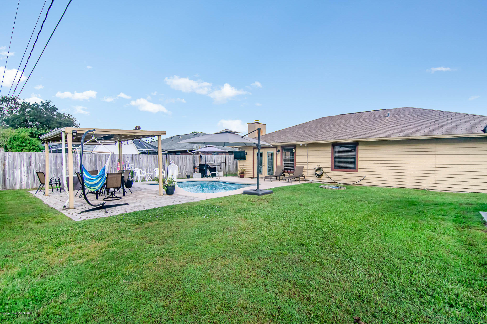484 Rheine Road Northwest Palm Bay, FL 32907 - Photo 22 of 24 a view of a house with backyard and sitting area