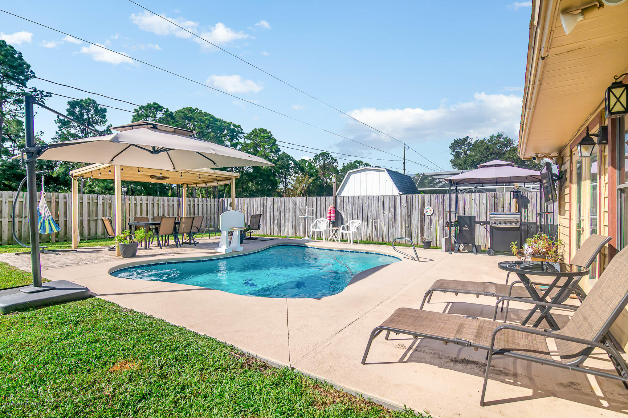 484 Rheine Road Northwest Palm Bay, FL 32907 - Photo 23 of 24 a view of a house with backyard and sitting area