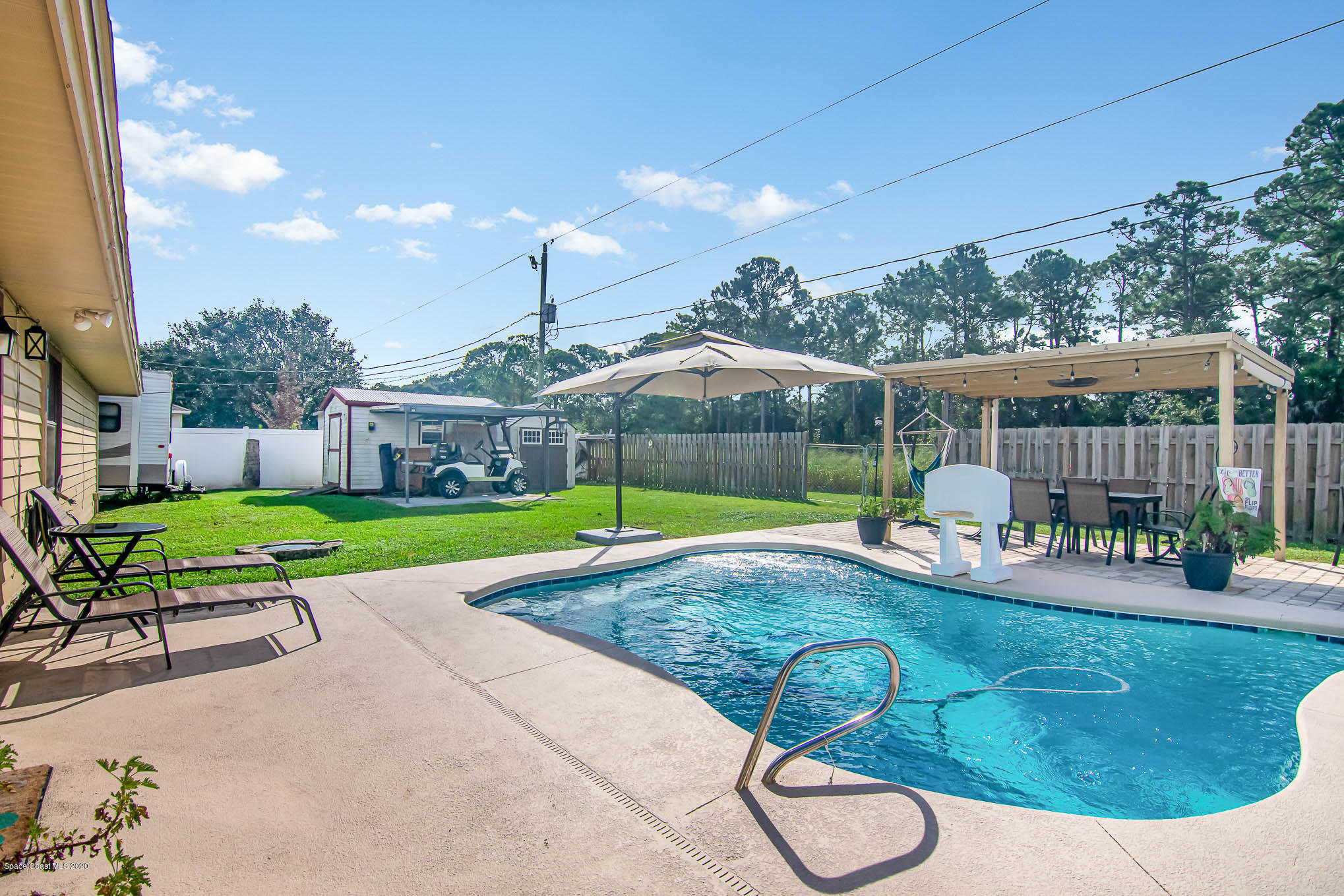 484 Rheine Road Northwest Palm Bay, FL 32907 - Photo 24 of 24 a view of a house with backyard and a slide