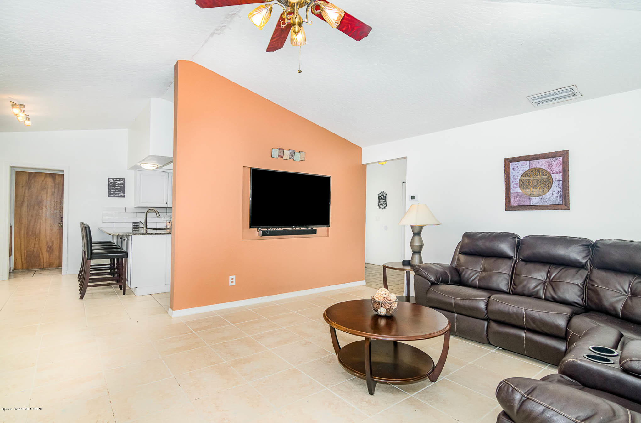 484 Rheine Road Northwest Palm Bay, FL 32907 - Photo 6 of 24 a living room with furniture and a flat screen tv