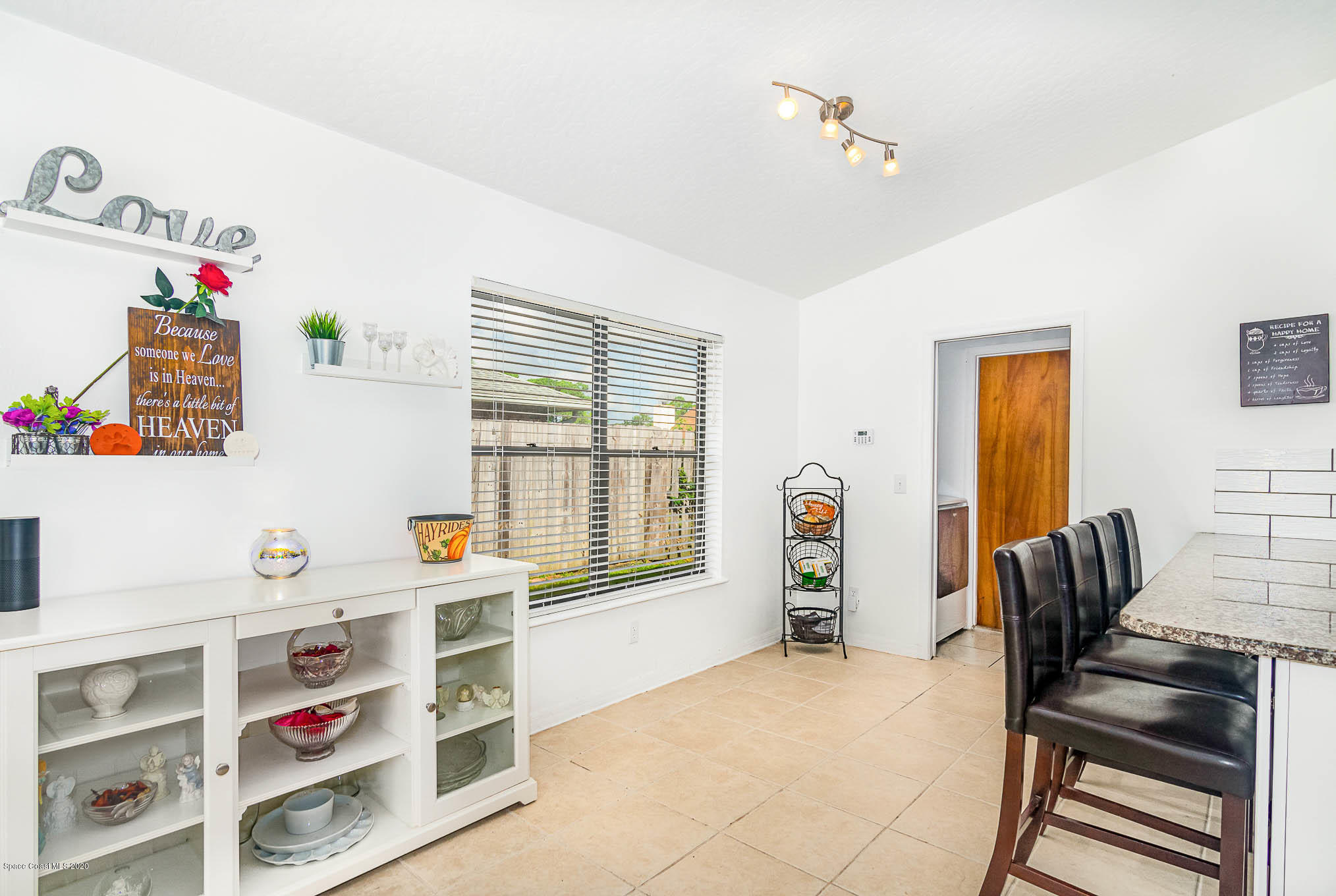 484 Rheine Road Northwest Palm Bay, FL 32907 - Photo 7 of 24 a bedroom with furniture a window and a ceiling fan