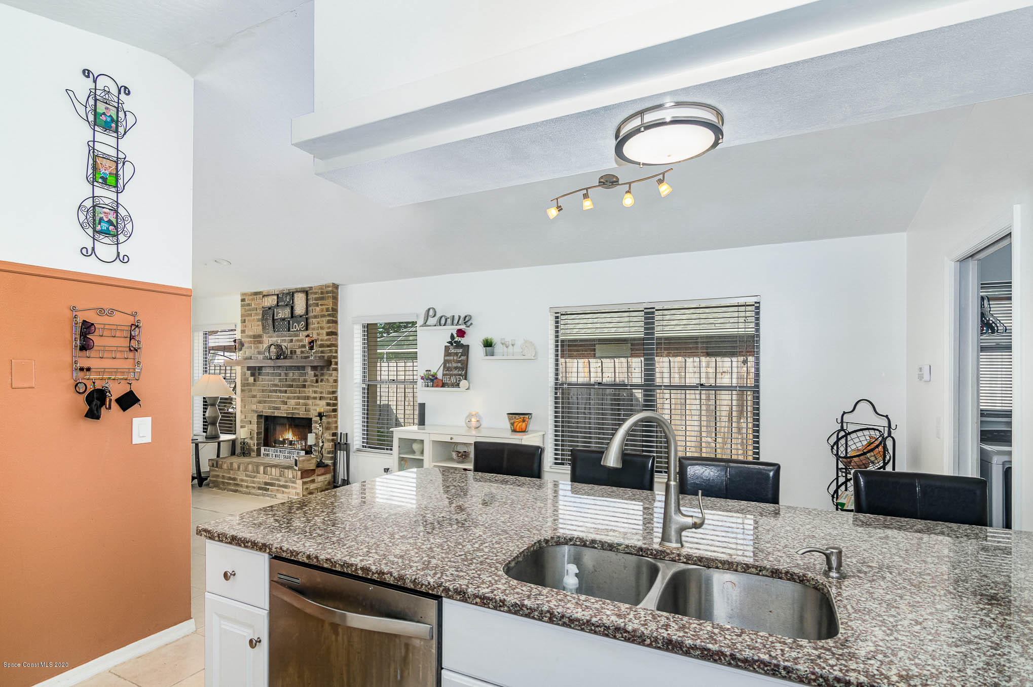 484 Rheine Road Northwest Palm Bay, FL 32907 - Photo 10 of 24 a kitchen with stainless steel appliances granite countertop a sink a counter space and cabinets