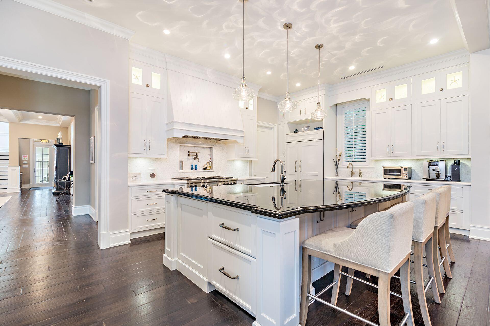 1222 North Ocean Boulevard Gulf Stream, FL 33483 - Photo 12 of 61 a kitchen with stainless steel appliances kitchen island granite countertop a sink and cabinets