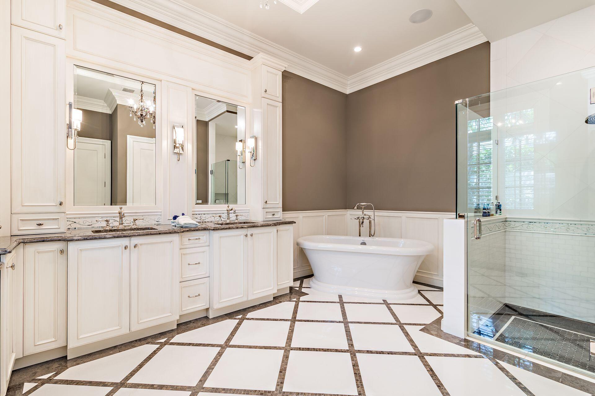 1222 North Ocean Boulevard Gulf Stream, FL 33483 - Photo 14 of 61 a bathroom with a double vanity sink a mirror and a bathtub