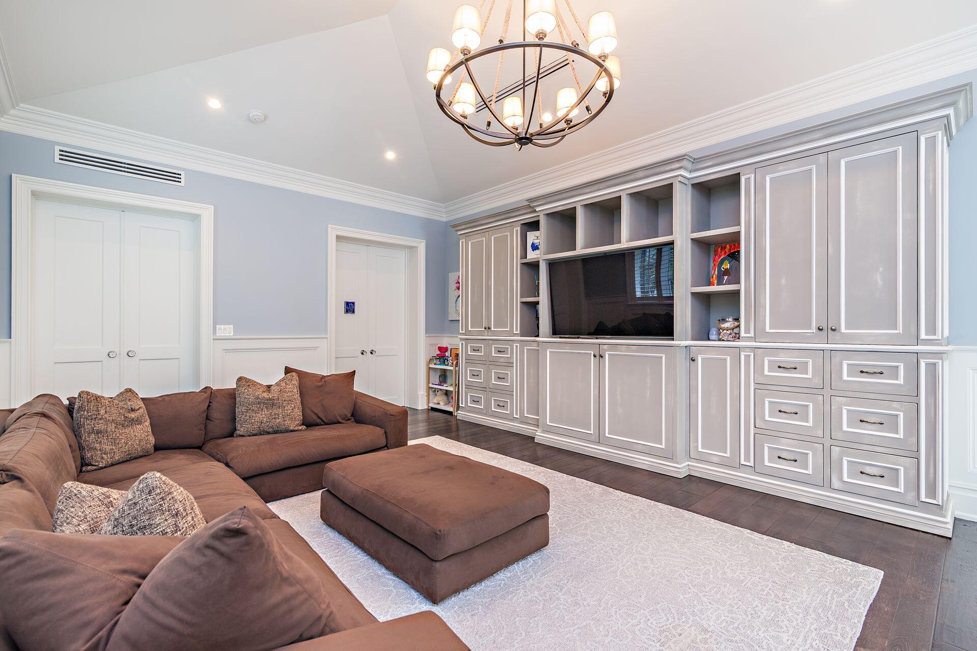 1222 North Ocean Boulevard Gulf Stream, FL 33483 - Photo 18 of 61 a living room with furniture a flat screen tv and a chandelier